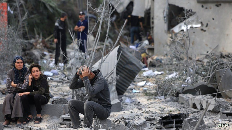 A man reacts as he sits amidst the rubble of a house after an Israeli strike in Khan Yunis, in the southern Gaza Strip on November 22, 2023, amid ongoing battles between Israel and the Palestinian Hamas movement. (Photo by MAHMUD HAMS / AFP)