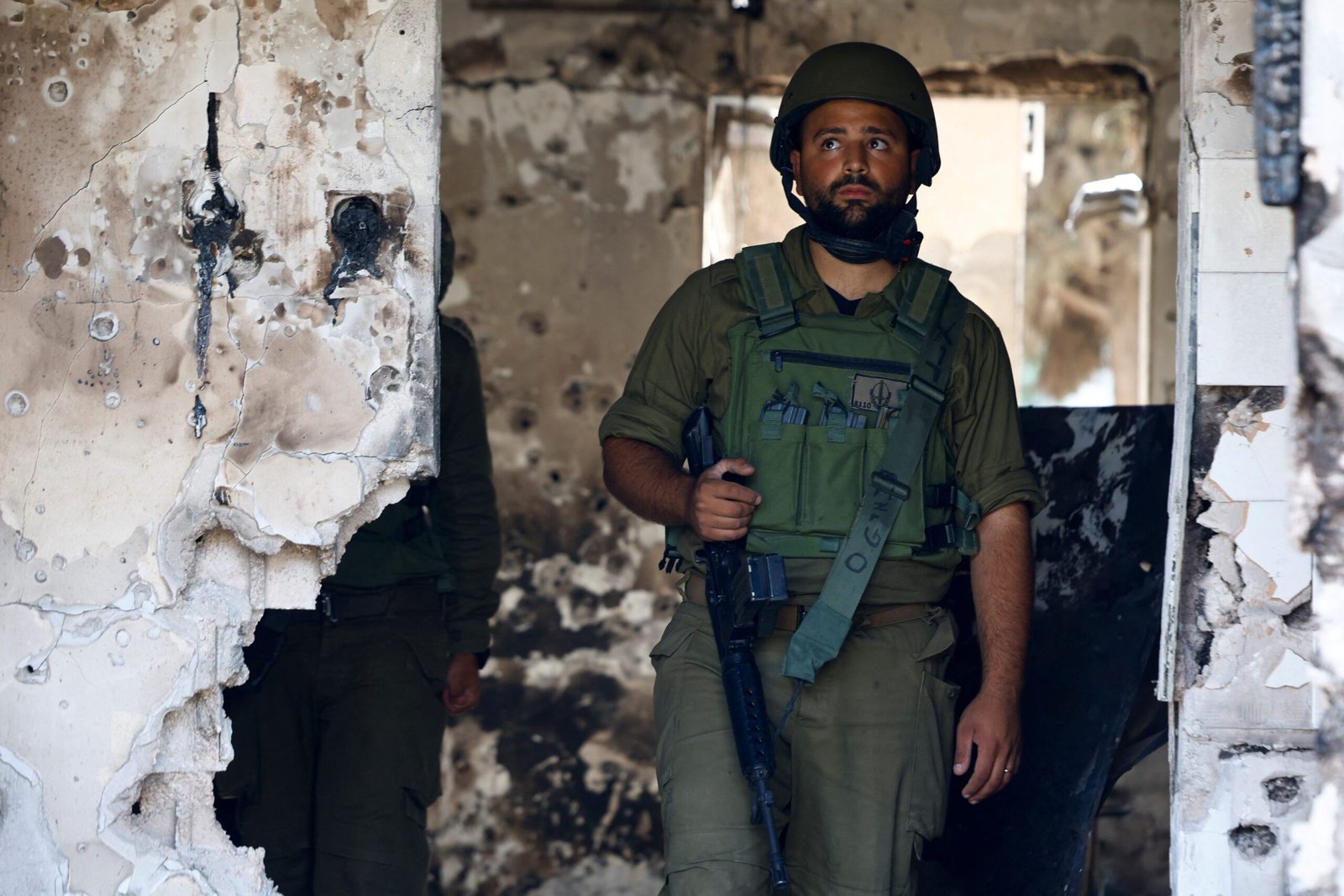 A soldier looks on in a destroyed home riddled with bullets, following the deadly October 7 attack by Hamas gunmen from the Gaza Strip, in Kibbutz Kfar Aza, southern Israel November 2, 2023. REUTERS/Evelyn Hockstein  REFILE - QUALITY REPEAT