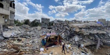 A Palestinian boy from Zawaraa family walks near their makeshift tent amid the rubble of their houses which were destroyed by Israeli air strikes during the Israeli-Palestinian fighting in Gaza May 23, 2021. Picture taken May 23, 2021. REUTERS/Mohammed Salem