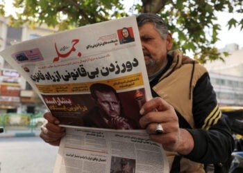 FILE PHOTO: An Iranian man reads a newspaper with a picture of Syrian President Bashar al-Assad in Tehran, Iran December 8, 2024. Majid Asgaripour/WANA (West Asia News Agency) via REUTERS ATTENTION EDITORS - THIS PICTURE WAS PROVIDED BY A THIRD PARTY/File Photo