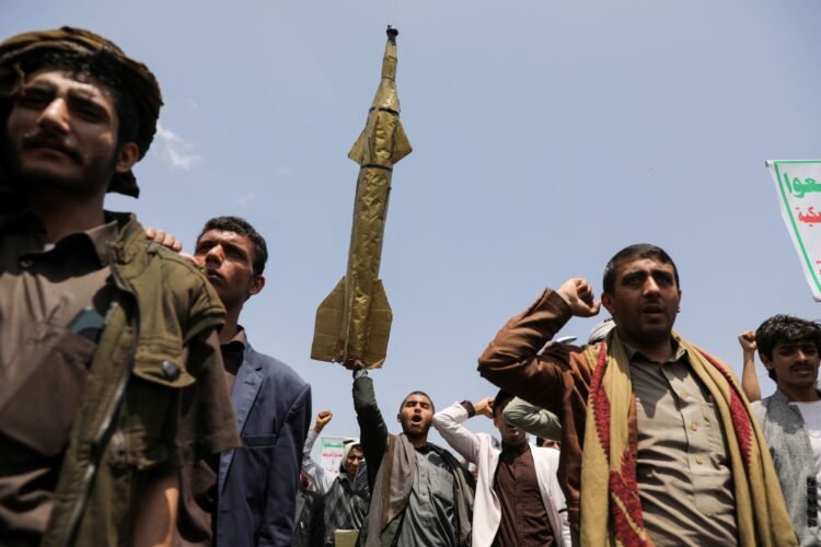A student holds up a mock missile during a demonstration by students and university professors, mainly Houthi supporters, in solidarity with Palestinians at the campus of Sanaa University in Sanaa, Yemen August 21, 2024. REUTERS/Khaled Abdullah - RC28K9AF63LK