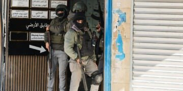 Palestinian security forces take position during clashes with militants at the camp, in Jenin in the Israeli-occupied West Bank, December 14, 2024. REUTERS/Raneen Sawafta