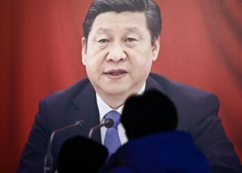 People look at a portrait of Chinese President Xi Jinping at the Museum of the Communist Party of China in Beijing on February 23, 2025, ahead of the opening of the annual session of the National People’s Congress on March. (Photo by Pedro PARDO / AFP)