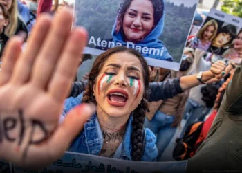 photo of woman holding up hand that says help