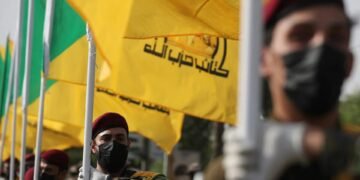 kataeb hezbollah funeral iraq flags afp.jpg