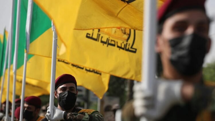 kataeb hezbollah funeral iraq flags afp.jpg