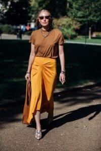 Neutral Earth Tone Color Trend Summer Outfit Inspiration Aviator Sunglasses Chain Necklace Brown T Shirt Orange Midi Skirt Python Snakskin Mule Heels Vogue Italy Street Style Le Fashion Blog