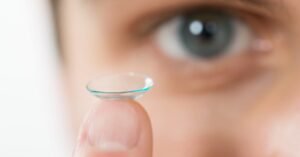 close up contact lense on finger