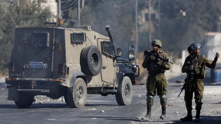 Members of the Israeli security forces stand during clashes following the funeral of seven-year-old Palestinian boy Rayyan Suleiman, who according to his father has died of heart failure while being chased by Israeli soldiers, east of Bethlehem, Israeli-occupied West Bank September 30, 2022. REUTERS/Mussa Qawasma