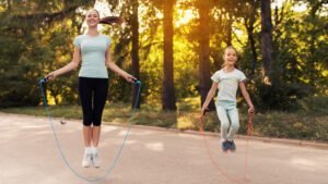 woman girl jumping rope in park 856960322