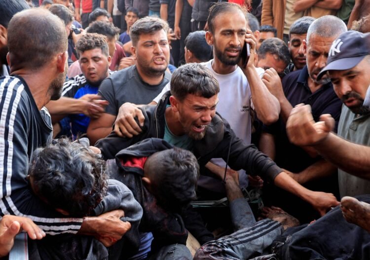 SENSITIVE MATERIAL. THIS IMAGE MAY OFFEND OR DISTURB Palestinians react next to people wounded in an Israeli strike while waiting for aid, according to the Gaza Health Ministry, at Nasser hospital, in Khan Younis, southern Gaza Strip, June 17, 2025. REUTERS/Hatem Khaled     TPX IMAGES OF THE DAY