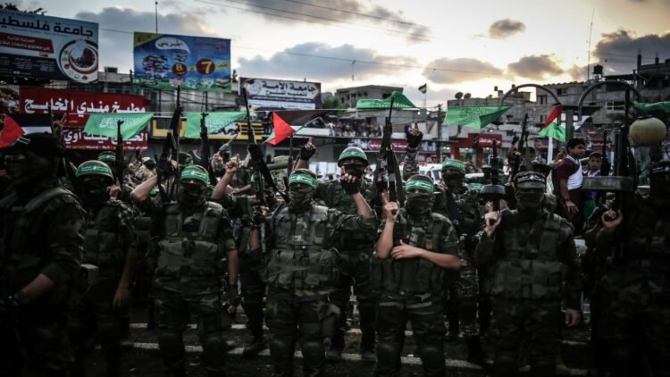 GAZA CITY, GAZA - AUGUST 21: Members of Ezzedin al-Qassam Brigades, the armed wing of the Hamas movement, take part in a military parade marking the one-year death anniversary of three al-Qassam commanders Raed al-Attar, Mohammed Abu Shamala, and Mohammed Barhoum on August 21, 2015 in Rafah town, southern Gaza Strip. (Photo by Ali Hassan/Anadolu Agency/Getty Images)